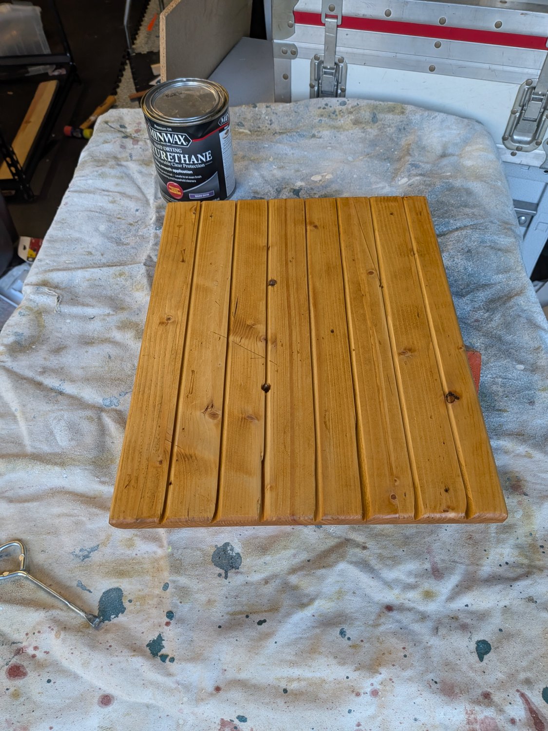 Finished grooved wooden piece beside a can of polyurethane